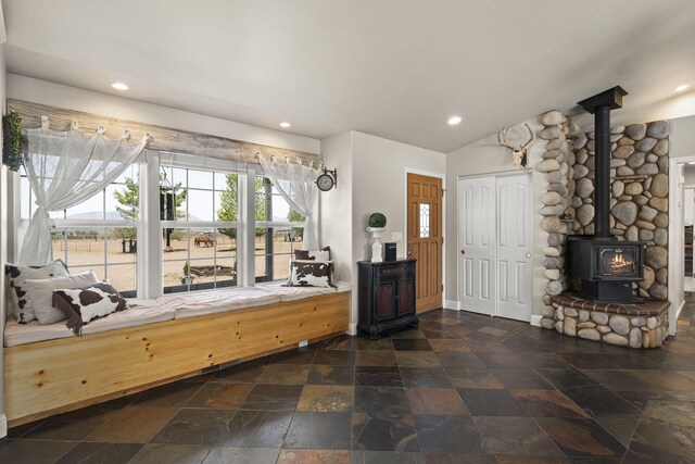 4800 Amy Rd, Reno, NV 89510 - entryway featuring a wood stove, stone tile floors, recessed lighting, lofted ceiling, and baseboards