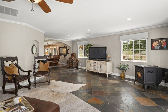 4800 Amy Rd, Reno, NV 89510 - living area featuring stone tile flooring, baseboards, plenty of natural light, ornamental molding, and a wood stove