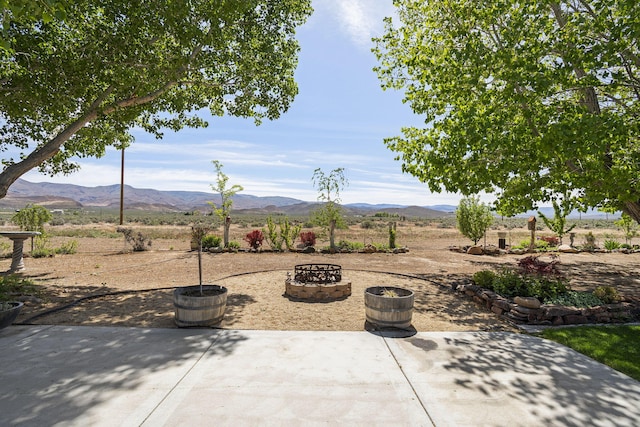 4800 Amy Rd, Reno, NV 89510 - view of patio / terrace featuring a fire pit, a mountain view, and a view of countryside