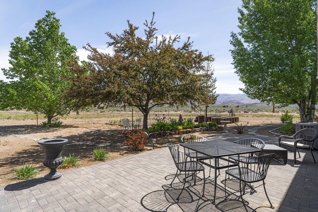 4800 Amy Rd, Reno, NV 89510 - view of patio / terrace featuring a mountain view, outdoor dining area, and central AC unit