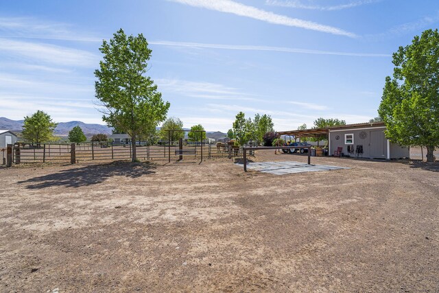 4800 Amy Rd, Reno, NV 89510 - view of yard with a mountain view, fence, and an outdoor structure