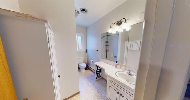 50 Bellevue Ave, Winnemucca, NV 89445 - bathroom featuring toilet, vanity, and baseboards