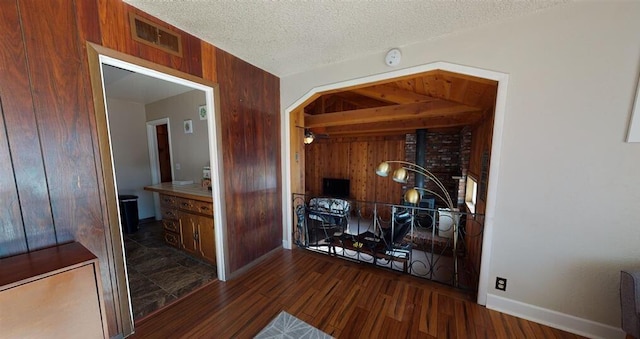 50 Bellevue Ave, Winnemucca, NV 89445 - hall featuring wood walls, dark wood-style floors, a textured ceiling, and baseboards
