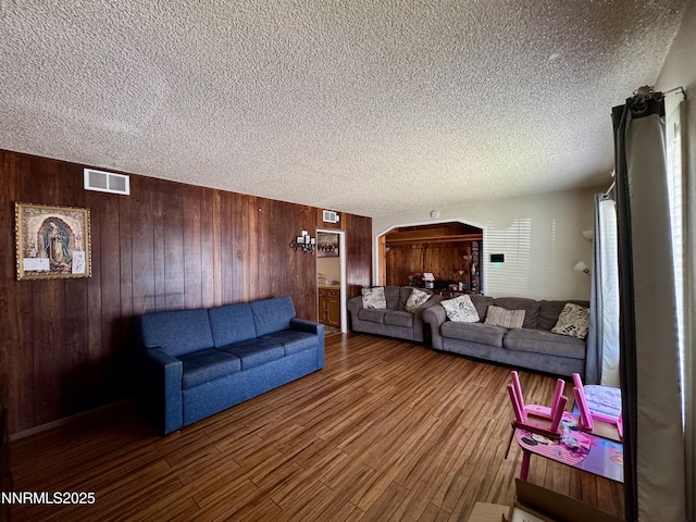 50 Bellevue Ave, Winnemucca, NV 89445 - living area with a textured ceiling, wood walls, and wood finished floors