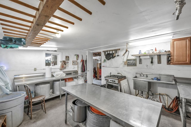 1000 Sagebrush Ct, Gardnerville, NV 89460 - kitchen featuring concrete floors, brown cabinetry, stainless steel countertops, and a breakfast bar