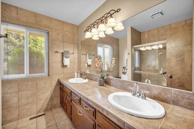 1000 Sagebrush Ct, Gardnerville, NV 89460 - bathroom featuring a shower stall, tile patterned floors, double vanity, and tile walls
