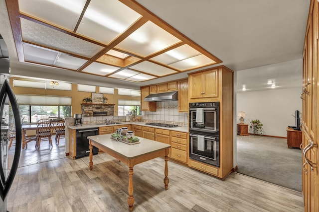 1000 Sagebrush Ct, Gardnerville, NV 89460 - kitchen with black appliances, under cabinet range hood, tasteful backsplash, a peninsula, and light countertops