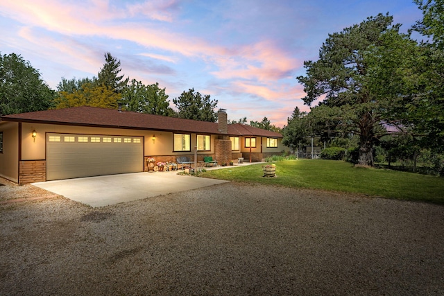 295 Andrew Ln, Reno, NV 89521 - ranch-style house with driveway, an attached garage, stone siding, a yard, and a chimney