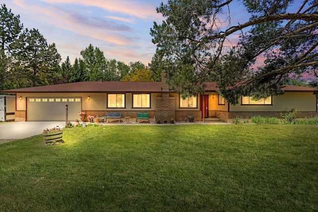 295 Andrew Ln, Reno, NV 89521 - ranch-style home with concrete driveway, a garage, a yard, brick siding, and a chimney