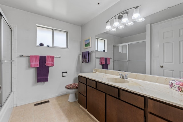 295 Andrew Ln, Reno, NV 89521 - bathroom with toilet, vanity, baseboards, shower / bath combination with glass door, and tile patterned flooring