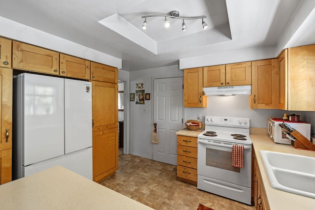 295 Andrew Ln, Reno, NV 89521 - kitchen with white appliances, under cabinet range hood, light countertops, and a sink