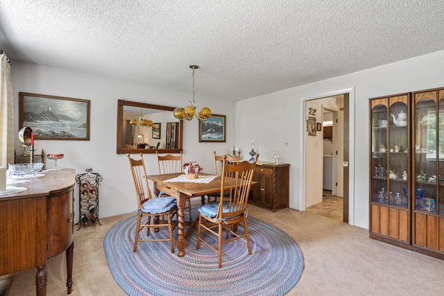 295 Andrew Ln, Reno, NV 89521 - dining area with light carpet, a chandelier, and a textured ceiling