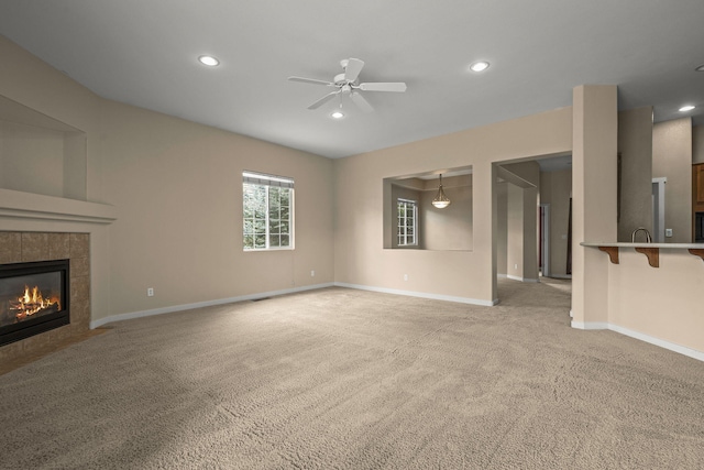 1196 Turnberry Dr, Sparks, NV 89436 - unfurnished living room with light carpet, a tiled fireplace, recessed lighting, a ceiling fan, and baseboards