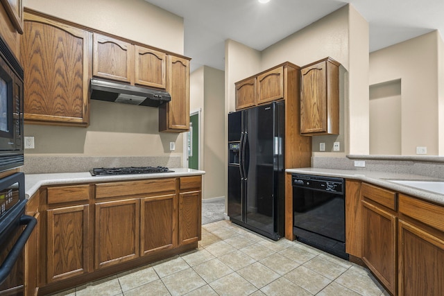1196 Turnberry Dr, Sparks, NV 89436 - kitchen with black appliances, under cabinet range hood, light tile patterned floors, and light countertops
