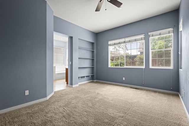 1196 Turnberry Dr, Sparks, NV 89436 - unfurnished bedroom with carpet, baseboards, ceiling fan, and connected bathroom
