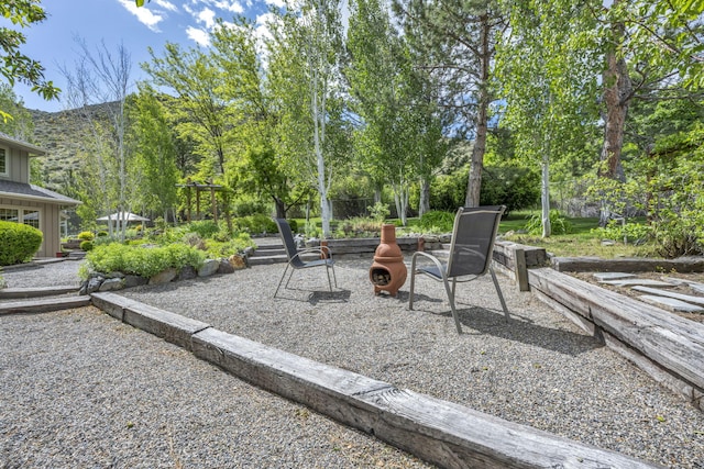 3150 Kings Canyon Rd, Carson City, NV 89703 - view of patio / terrace with a mountain view and an outdoor fire pit