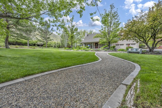 3150 Kings Canyon Rd, Carson City, NV 89703 - view of green lawn with a garage