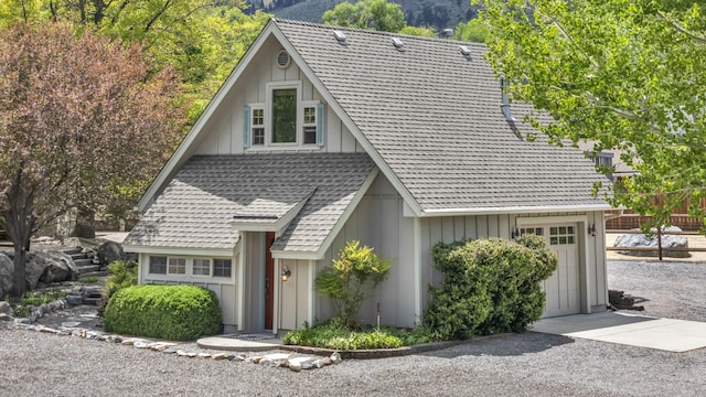 3150 Kings Canyon Rd, Carson City, NV 89703 - view of front of home with a mountain view, an attached garage, driveway, and board and batten siding