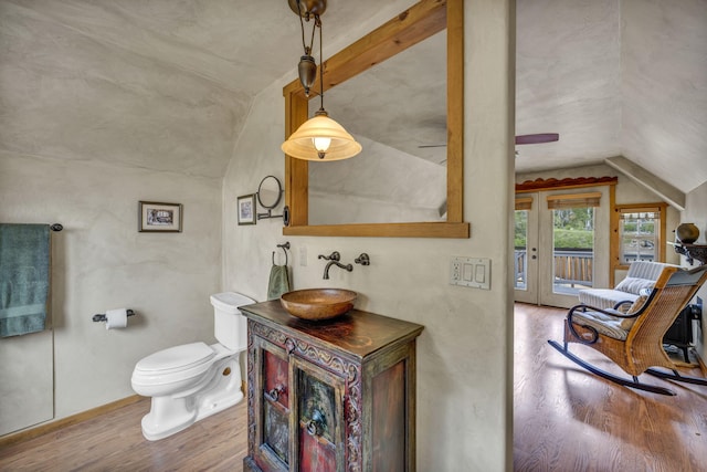 3150 Kings Canyon Rd, Carson City, NV 89703 - bathroom with vaulted ceiling, wood finished floors, vanity, toilet, and ceiling fan