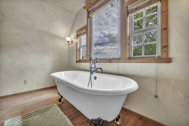 3150 Kings Canyon Rd, Carson City, NV 89703 - full bathroom with a soaking tub, baseboards, wood finished floors, and vaulted ceiling