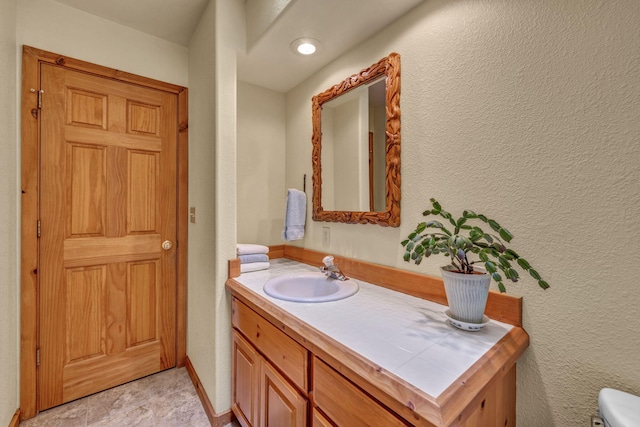 3150 Kings Canyon Rd, Carson City, NV 89703 - half bathroom with vanity, toilet, and a textured wall