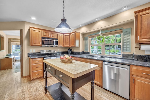 3150 Kings Canyon Rd, Carson City, NV 89703 - kitchen with stainless steel appliances, a sink, wood counters, light wood-style floors, and decorative light fixtures