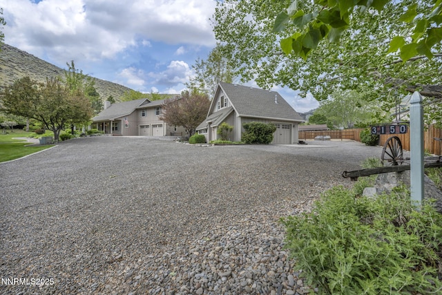 3150 Kings Canyon Rd, Carson City, NV 89703 - view of front of house with a garage, driveway, and a chimney