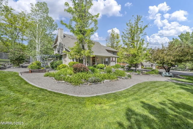 3150 Kings Canyon Rd, Carson City, NV 89703 - view of side of home with a lawn, a chimney, and roof with shingles
