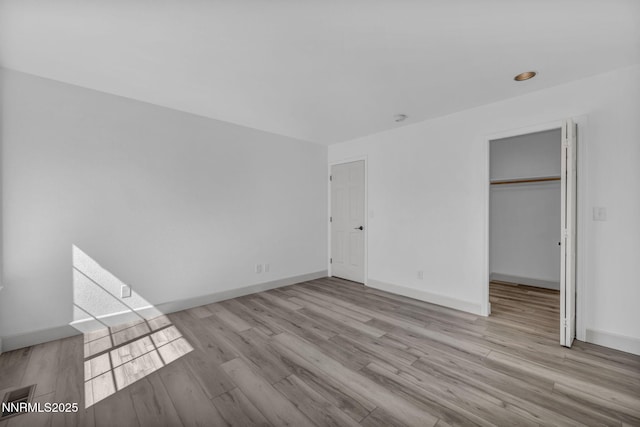 185 Windtree Cir, Carson City, NV 89701 - unfurnished bedroom featuring wood finished floors, baseboards, a walk in closet, and a closet