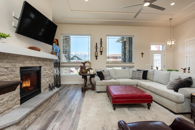 1023 Sun Crest Ct, Gardnerville, NV 89460 - living room with wood finished floors, a tray ceiling, a ceiling fan, a fireplace, and recessed lighting