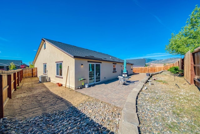1390 Tule Peak Cir, Carson City, NV 89701 - back of house with stucco siding, central AC unit, a fenced backyard, and a patio area
