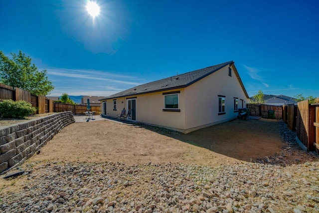 1390 Tule Peak Cir, Carson City, NV 89701 - back of property featuring stucco siding, a fenced backyard, and a patio area