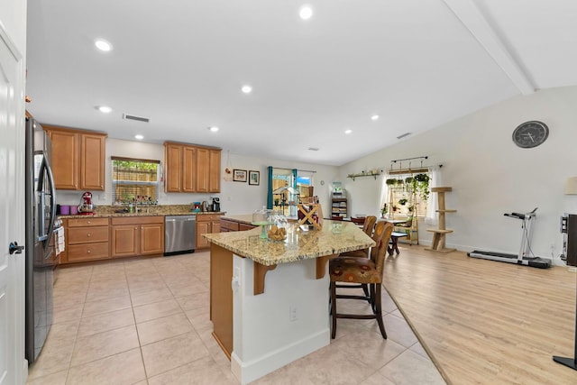 1390 Tule Peak Cir, Carson City, NV 89701 - kitchen featuring dishwasher, a breakfast bar area, recessed lighting, light stone counters, and black fridge with ice dispenser