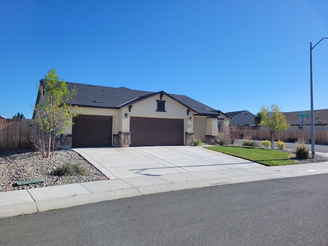 1390 Tule Peak Cir, Carson City, NV 89701 - view of front of house with a garage, stucco siding, concrete driveway, and stone siding
