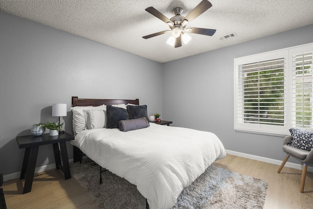 2107 G St, Sparks, NV 89431 - bedroom featuring wood finished floors, baseboards, a textured ceiling, and a ceiling fan