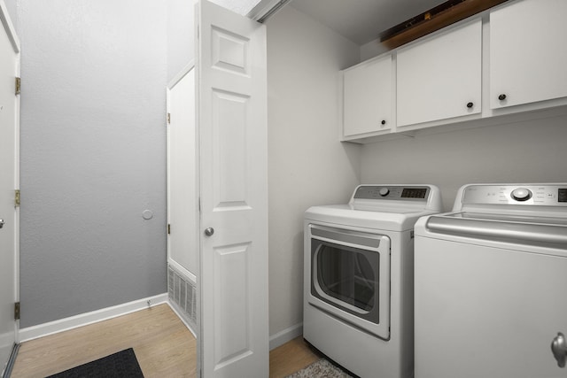 2107 G St, Sparks, NV 89431 - clothes washing area featuring cabinet space, washer and clothes dryer, light wood finished floors, and baseboards