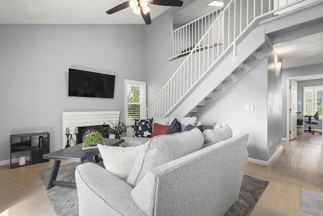 2107 G St, Sparks, NV 89431 - living room with stairway, baseboards, a ceiling fan, wood finished floors, and a towering ceiling
