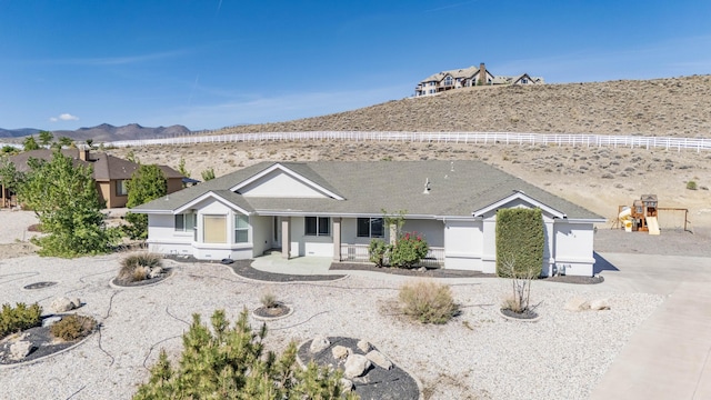 570 Buckskin Dr, Fernley, NV 89408 - ranch-style home featuring a mountain view, a shingled roof, and stucco siding