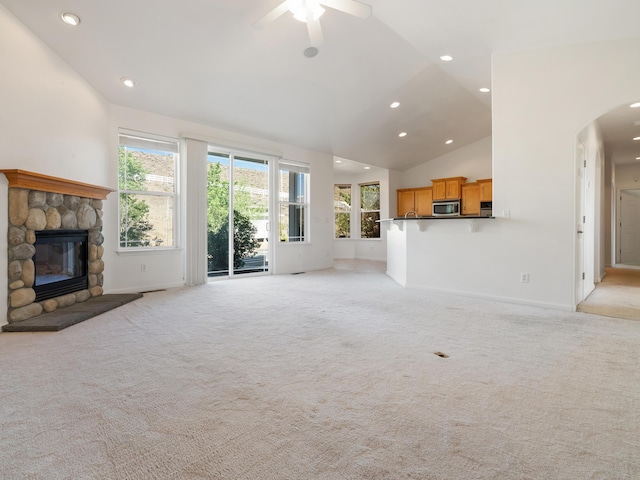570 Buckskin Dr, Fernley, NV 89408 - unfurnished living room featuring lofted ceiling, healthy amount of natural light, light carpet, a ceiling fan, and arched walkways