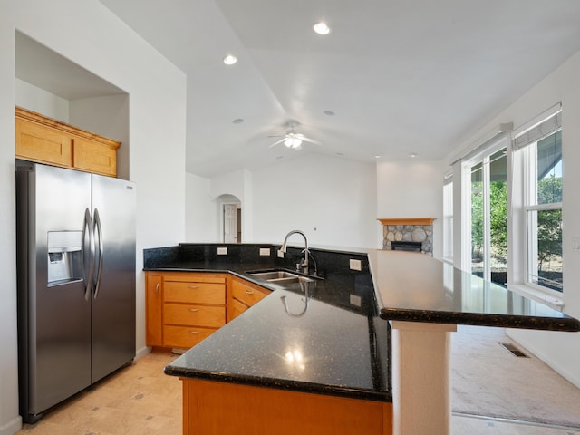 570 Buckskin Dr, Fernley, NV 89408 - kitchen featuring stainless steel refrigerator with ice dispenser, a sink, a fireplace, a ceiling fan, and a peninsula