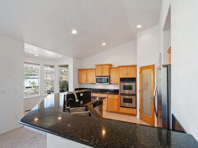 570 Buckskin Dr, Fernley, NV 89408 - kitchen featuring stainless steel appliances, a sink, recessed lighting, baseboards, and vaulted ceiling