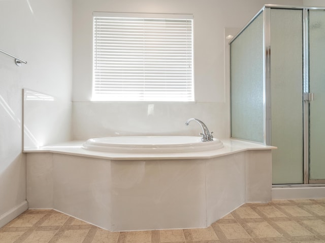 570 Buckskin Dr, Fernley, NV 89408 - full bath featuring plenty of natural light, a shower stall, a bath, and tile patterned floors