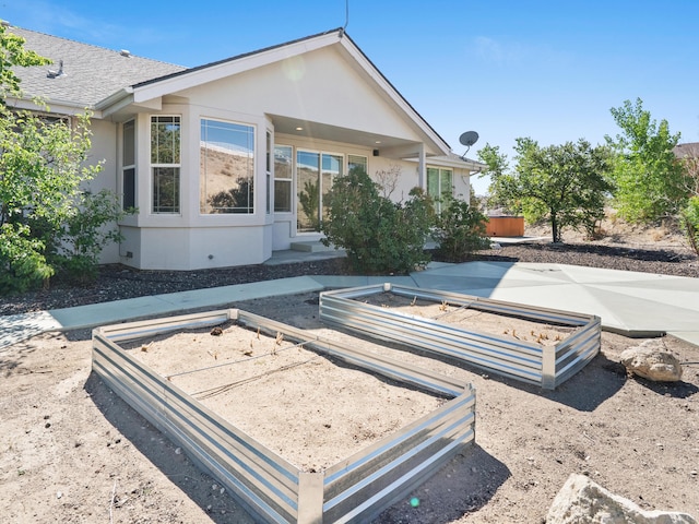 570 Buckskin Dr, Fernley, NV 89408 - rear view of property featuring a garden and stucco siding