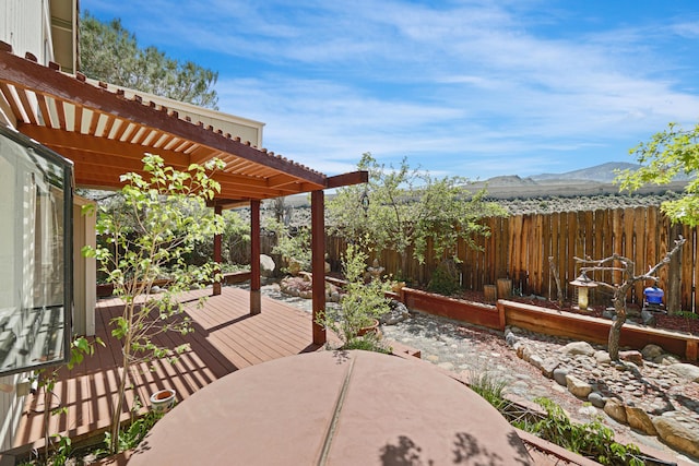 1043 Shenandoah Dr, Carson City, NV 89702 - view of patio with a pergola, a fenced backyard, a deck with mountain view, and outdoor dining space