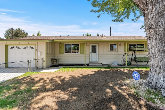 2580 Pequop St, Reno, NV 89512 - ranch-style house with concrete driveway, a garage, a gate, and board and batten siding