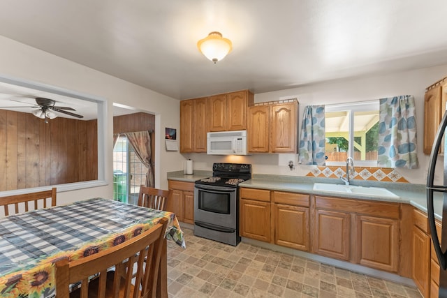 2580 Pequop St, Reno, NV 89512 - kitchen featuring white microwave, electric stove, a sink, light countertops, and a ceiling fan