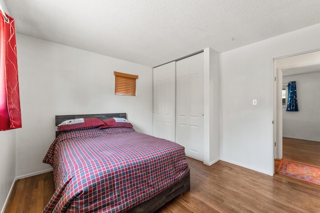 2580 Pequop St, Reno, NV 89512 - bedroom with wood finished floors, a closet, baseboards, and a textured ceiling