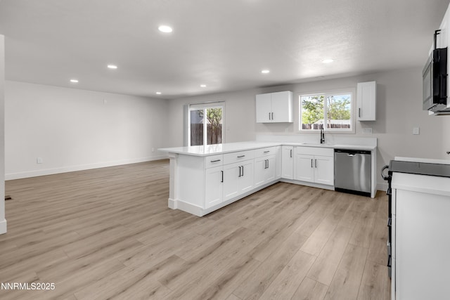 1717 Rio Tinto Dr, Sparks, NV 89434 - kitchen with stainless steel appliances, a peninsula, recessed lighting, white cabinetry, and light countertops