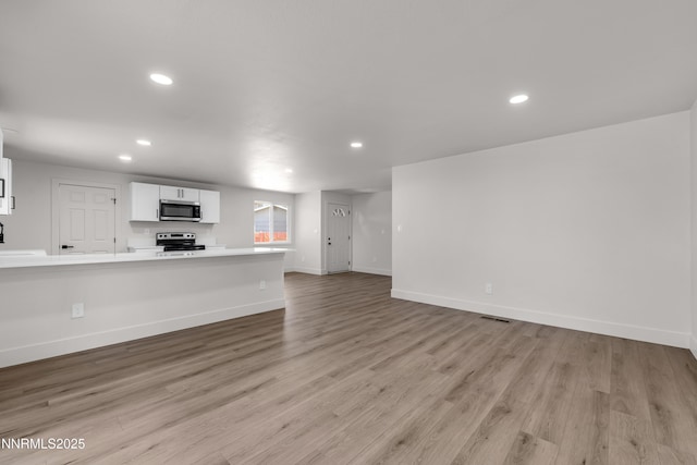 1717 Rio Tinto Dr, Sparks, NV 89434 - unfurnished living room featuring recessed lighting, light wood finished floors, and baseboards