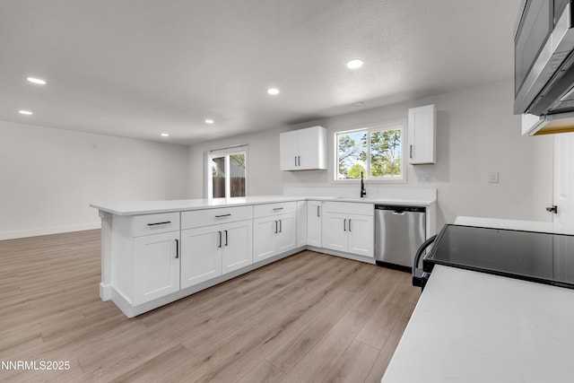1717 Rio Tinto Dr, Sparks, NV 89434 - kitchen with stainless steel appliances, a peninsula, recessed lighting, a sink, and white cabinets
